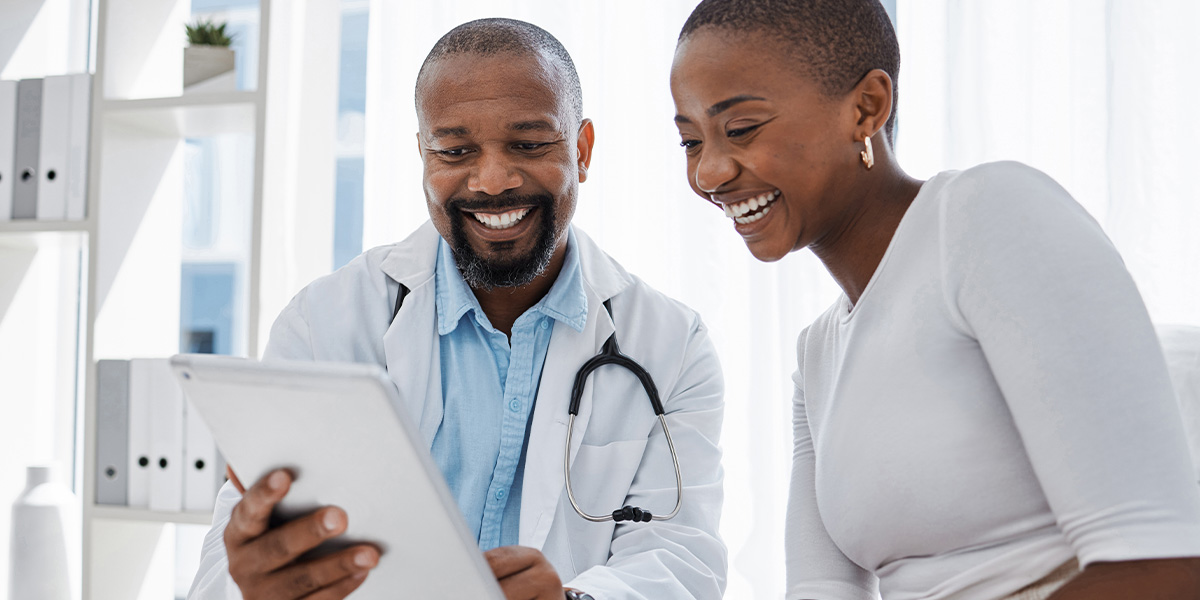 Smiling doctor and patient review blood work results