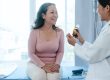 physician explains difference in bioidentical and synthetic hormones to female patient.
