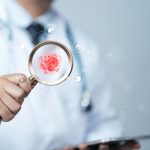 Doctor examining virus with magnifying glass