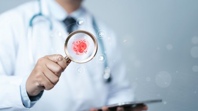 Doctor examining virus with magnifying glass