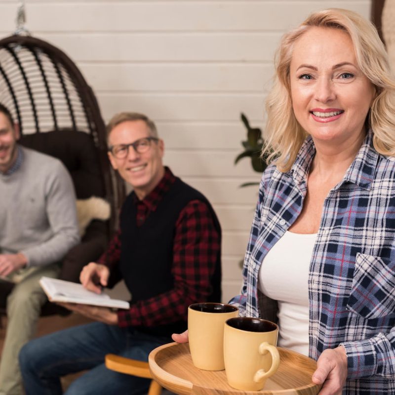 mother-holding-tray-cups-posing-with-family-background
